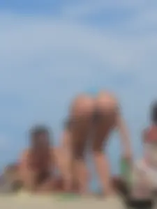 Sexy lady on the beach in a blue thong bikini