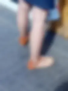 Teen feet in sandals and pantyhose on the street closeup photos