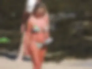 Blonde milf on the beach in her bikini