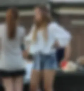 Hippie type dressed girl in denim shorts with a nice ass