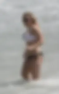Big boobed thick blonde on the beach in a bikini