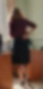 Hot teacher wearing stiletto heels and a skirt in classroom