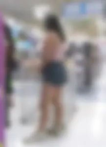 Candid girl in shorts at the supermarket