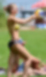 Sexy blonde girl in the park playing volleyball in her skimpy bikini