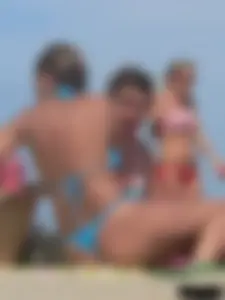 Sexy lady on the beach in a blue thong bikini
