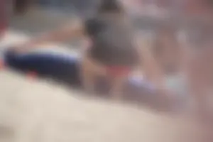 A group of teens in bikinis on the beach