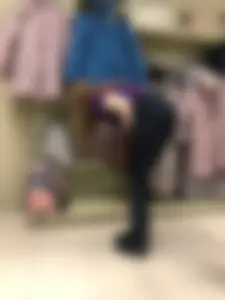 Cute candid shop assistant wearing boots and tight pants
