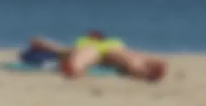 Sexy ass blonde milf on the beach in a thong with cameltoe and bending over