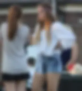 Hippie type dressed girl in denim shorts with a nice ass