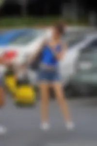 Sexy girl in denim shorts handcuffed to her friend outside