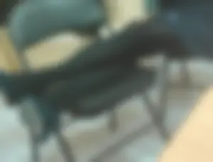 Candid College Teen in a Skirt, Black Pantyhose And High-Heeled Shoes Sitting With Her Crossed Slim Legs Put on a Chair Creepshot