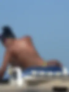 Hot ass topless beach girl with great tits lets her little brother oil up her ass in thong bikini