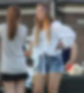 Hippie type dressed girl in denim shorts with a nice ass