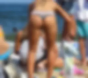 Sexy girl on the beach in a thong bikini with a nice ass