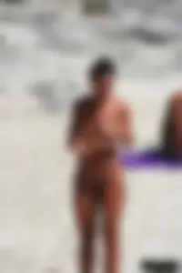 Smoking milf at a nude beach with a hairy pussy