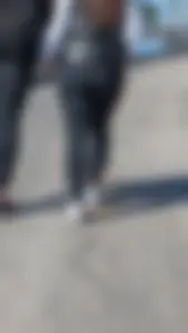 A beautiful little brunette walking in the park. tight black leggings