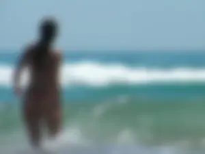 Sexy beach babe in orange thong and floral top