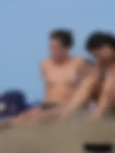Sexy babe with a nice body topless and in a thong on the beach