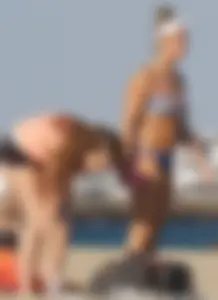 Beach babe in a blue bikini with thick friend in shorts