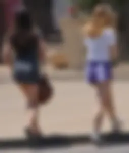 Sexy teen with glasses showing ass cheeks in shorts and friend in tight dress