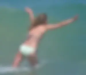 Milf at the beach in the water with hard nipples and a nice body