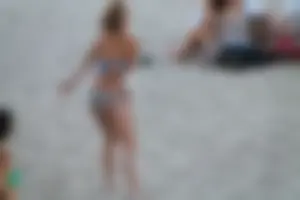 Sexy girl playing beach volleyball in a bikini