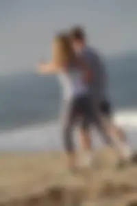 Skinny blonde on the beach in tight grey leggings
