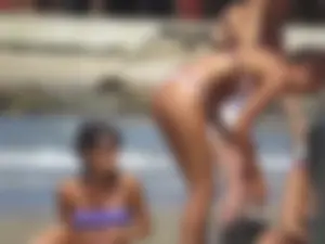 Girl with a great ass in thong bikini on the beach