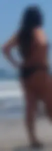 Thick brunette beach babe booty in a little black bikini