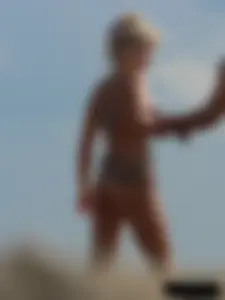 Tattooed blonde with big tits topless and in thong