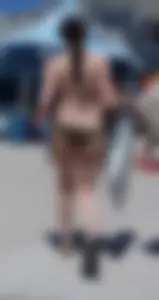 Girl in a tiny brown floral bikini showing some cheek and crack
