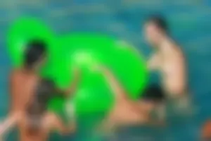 FKK Nudists playing in the water with floater