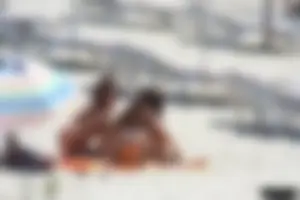 Topless milf and her topless daughter on the beach