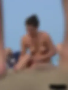 Sexy babe with a nice body topless and in a thong on the beach
