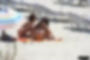 Topless milf and her topless daughter on the beach