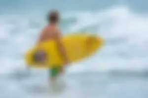 Candid girls surfing on the beach