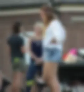 Hippie type dressed girl in denim shorts with a nice ass