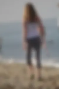 Skinny blonde on the beach in tight grey leggings