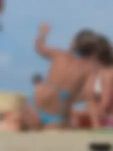Sexy lady on the beach in a blue thong bikini