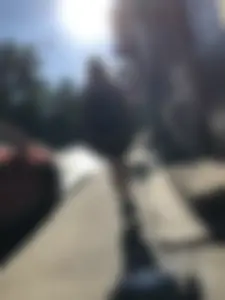 Skinny Girl in a Skirt Walking Down the Street and Hugging Her Friend Candid