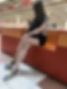 Girl with Hot Long Legs Sitting in the Mall Candid
