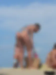Sexy lady on the beach in a blue thong bikini