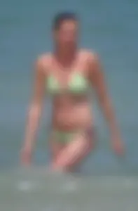 Milf at the beach in the water with hard nipples and a nice body