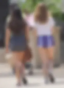 Sexy teen with glasses showing ass cheeks in shorts and friend in tight dress