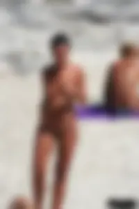 Smoking milf at a nude beach with a hairy pussy