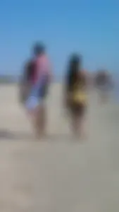 Beach babe with a nice ass and big tits in yellow thong bikini