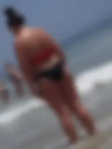 Thick brunette lady on the beach with a big booty