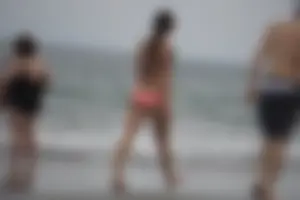 Peach bikini tattood babe on the beach with a nice ass and some camel toe