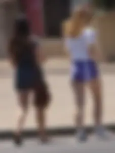 Sexy teen with glasses showing ass cheeks in shorts and friend in tight dress