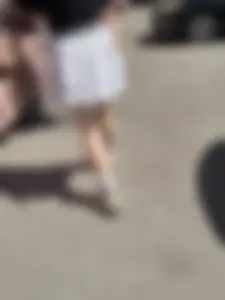Closeups of a hot girl’s pale legs, she’s wearing a skirt